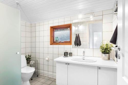 a white bathroom with a toilet and a sink at 1332-N-Vejby-Anemonevej-6 in Vejby