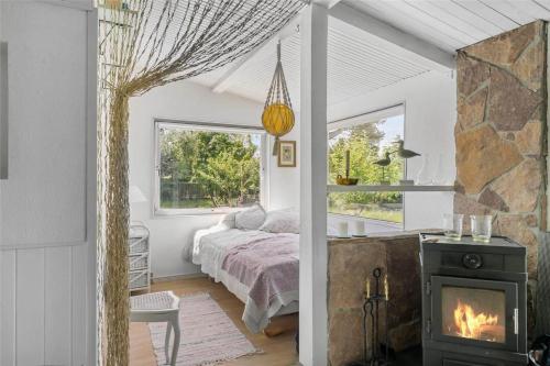 a bedroom with a bed and a fireplace at 1326-N-Liseleje-Parkvej-1 in Liseleje