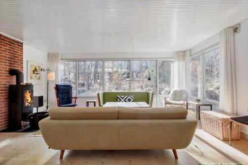 a living room with a couch and a fireplace at 1465-N-Frederiksvaerk-Skovsneppevej-6 in Frederiksværk
