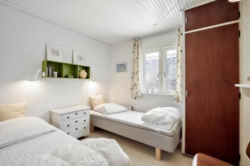 a bedroom with two beds and a window at 1465-N-Frederiksvaerk-Skovsneppevej-6 in Frederiksværk
