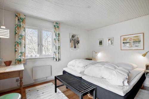 a bedroom with a bed with white sheets and a window at 1465-N-Frederiksvaerk-Skovsneppevej-6 in Frederiksværk