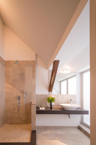 a bathroom with a sink and a shower at Hotel Oderberger in Berlin