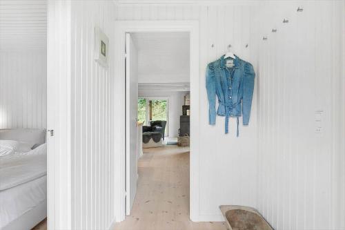a denim jacket hanging on a wall in a bedroom at 1587-Tisvildeleje-Stuebjergsvinget-3 in Tisvildeleje