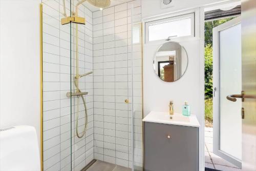 a bathroom with a shower and a sink and a mirror at 1586-Melby-Anna-Borgsvej-19 in Melby