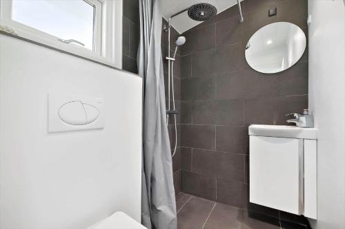 a bathroom with a toilet and a sink and a mirror at 872-N-Melby-Reinsholmvej-15 in Melby