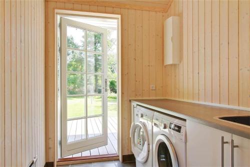 a kitchen with a washing machine and a window at 902-N-Tisvildeleje-Klovervej-9 in Tisvildeleje