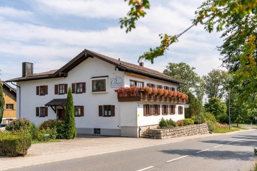 a white building with a flower box on it at Apartments Bauer in Grafing