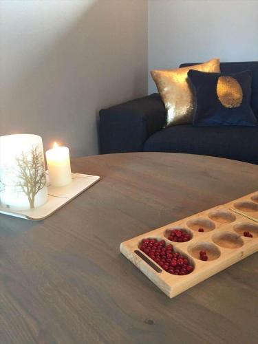 a table with a candle and a tray of berries at 1606-Liseleje-Lisevaenget-18 in Liseleje