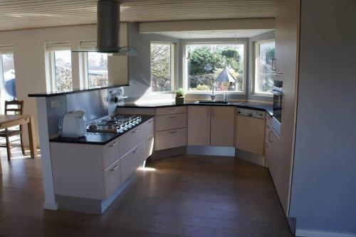 a kitchen with a sink and a stove top oven at 1606-Liseleje-Lisevaenget-18 in Liseleje