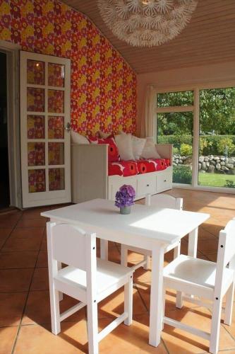 a room with a white table and chairs and a bed at 1606-Liseleje-Lisevaenget-18 in Liseleje