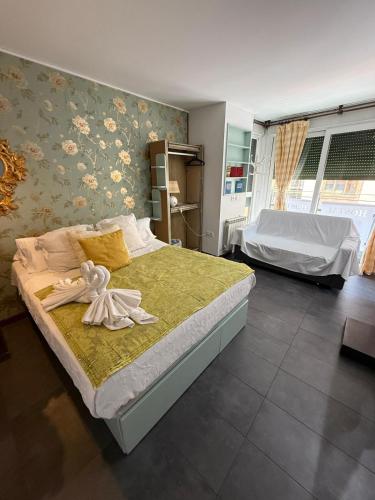 a bedroom with a bed with a towel on it at Hostal Rual in Cuenca
