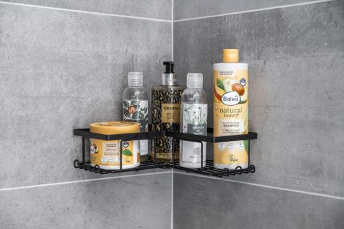 a shelf in a bathroom with bottles of alcohol at Cosy and Modern Apartment Labska Spindl in Krausovy Boudy