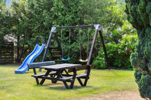 a playground with a bench and a slide at 1630-Frederiksvaerk-Munkebakken-2 in Frederiksværk