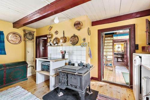 a kitchen with an old stove in a room at 1102-N-Hundested-Skansevej-45 in Hundested