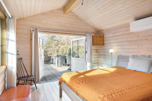 a bedroom with a bed and a sliding glass door at 1517-Melby-Lindebjergvej-78 in Melby