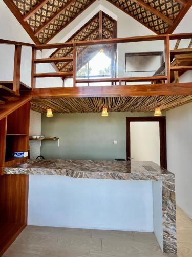 a room with a large counter with a loft at Villa Suaka by Sackstone in Watukarung