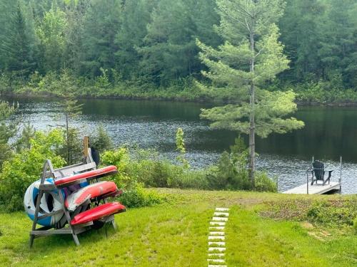 a group of kayaks sitting on the grass near a lake at LAKE and SPA - Le Matit 21 in Saint Come