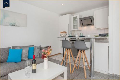 a living room with a couch and a kitchen at Ferienanlage Bansin Seepferdchen 1 in Bansin