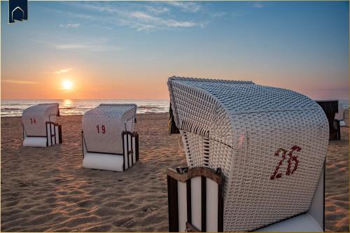 a group of beach chairs on the sand on the beach at Ferienanlage Bansin Seepferdchen 4 in Bansin