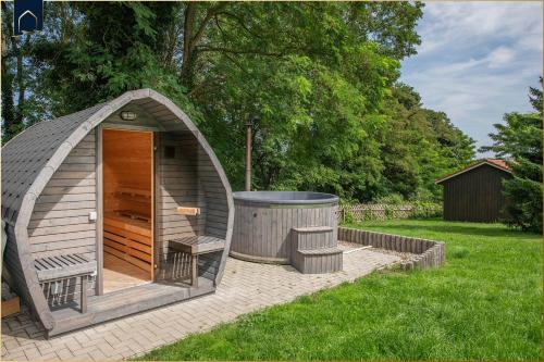a gazebo with a hot tub in a yard at Ferienanlage Bansin Seepferdchen 6 in Bansin