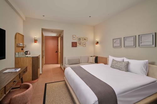 a hotel room with a large bed and a television at Paloma Grida in Belek
