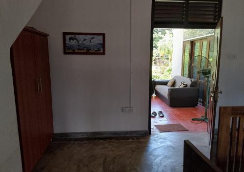 a hallway with a living room with a couch at Genge Lake Resort - Kalpitiya in Pallivasalturai
