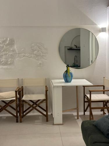 a living room with a table and a mirror at Allegra's Guest House in Ostuni