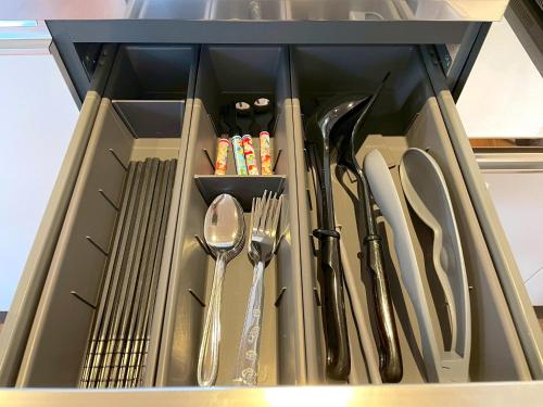 a drawer filled with utensils in a kitchen at Shibamata house self check in in Tokyo