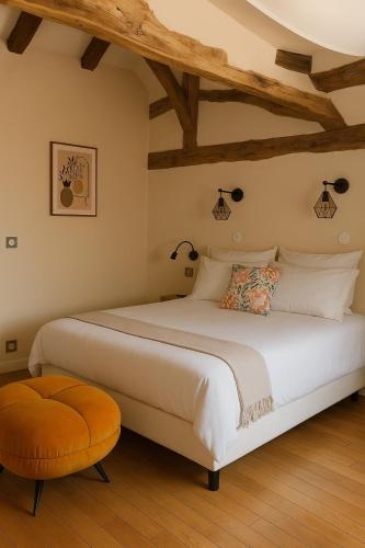 Giường trong phòng chung tại Le Nid Des Prés Gîtes & Spa