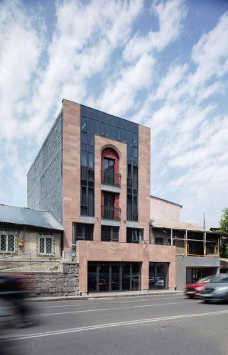 a building on a street with cars in front of it at AREA Hotel Yerevan in Yerevan