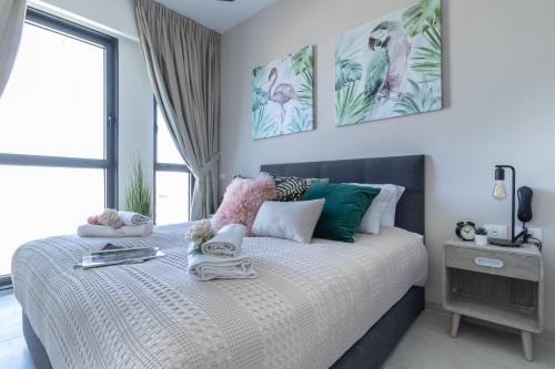 a bedroom with a bed with towels on it at New apartment in the heart of Jerusalem ! in Jerusalem