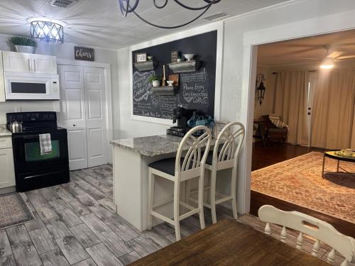 a kitchen with a counter with chairs and a table at Old Homosassa Living! Seconds to all the action! in Homosassa
