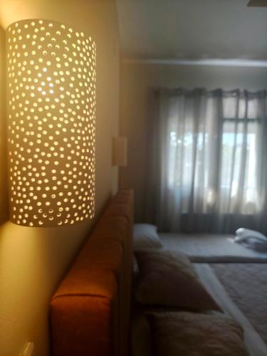 a living room with a couch and a lamp at Gastouni Urban stay in Gastoúni