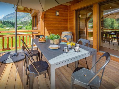 a table on the deck of a cabin at Chalet Les Vardafes - OVO Network in La Chapelle-dʼAbondance