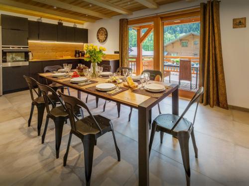 a dining room table and chairs in a kitchen at Chalet Les Vardafes - OVO Network in La Chapelle-dʼAbondance