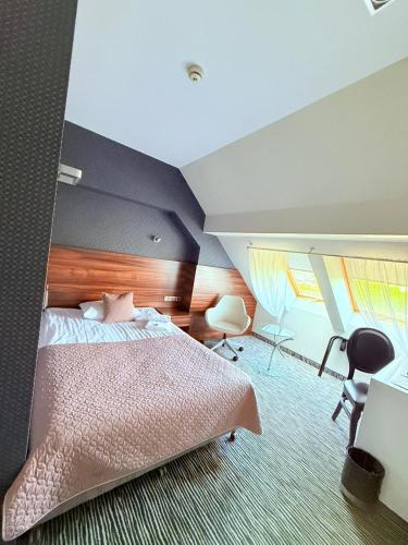 a bedroom with a pink bed in a room at Hotel Gorczowski Katowice Chorzów in Chorzów