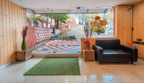 a living room with a couch and a rug at Flutter Hotels & Resort in Lansdowne