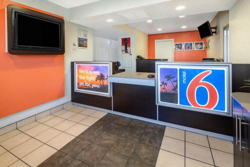 a fast food restaurant with a bar with a tv on the wall at Jurupa Valley, CA - Riverside West 