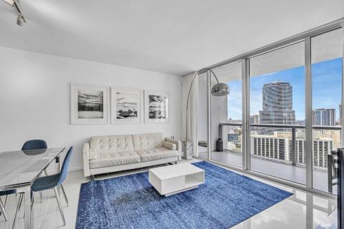 a living room with a couch and a table at Icon Brickell Residences by Skyline Rentals in Miami