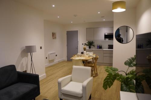 a living room with a table and a dining room at Stylish & Cozy 1bed apartment in city centre in Birmingham