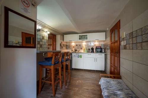 a kitchen with a table and some chairs in it at Rigó Lak in Miskolc