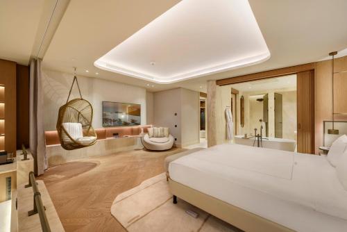 a bedroom with a large bed and a bath room at Regnum The Crown in Belek