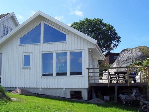 a white house with a large window on the side of it at 4 person holiday home in HENÅN-By Traum in Henån