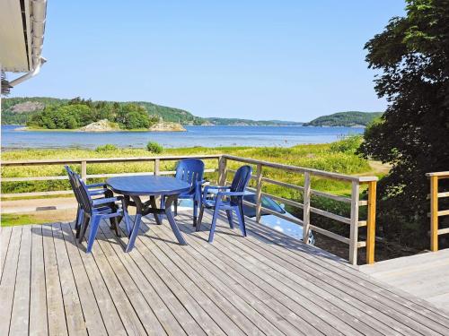 a table and chairs on a deck with a view of the water at 4 person holiday home in HENÅN-By Traum in Henån