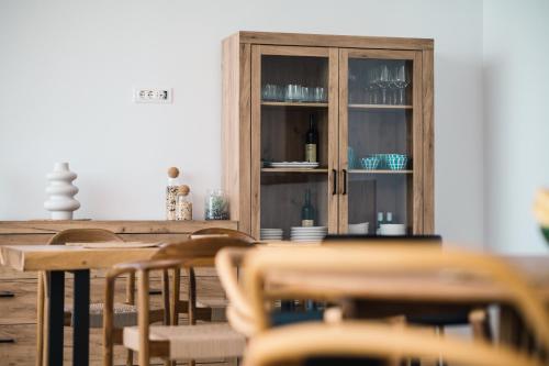 a dining room with a cabinet with dishes in it at KAAB Boutique Hotel in Ulcinj