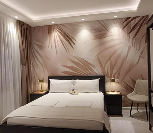 a bedroom with a large bed with a flowery wall at Dom City Apartments in Trento