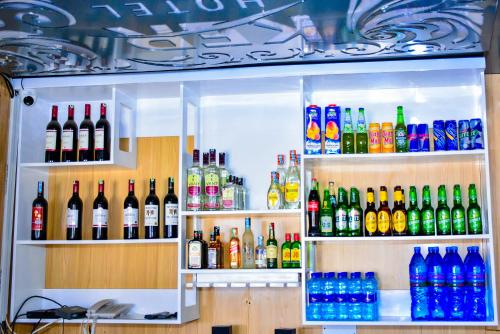 a refrigerator filled with lots of bottles of alcohol at KER HOTEL Dodoma in Dodoma