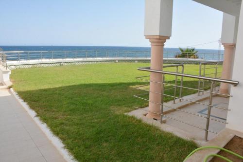 a balcony with a view of the ocean at Marrakech Style Seaside Escape in Kelibia