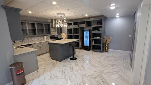 a large kitchen with a white marble floor at 2 bedrooms with movie theater in Agawam