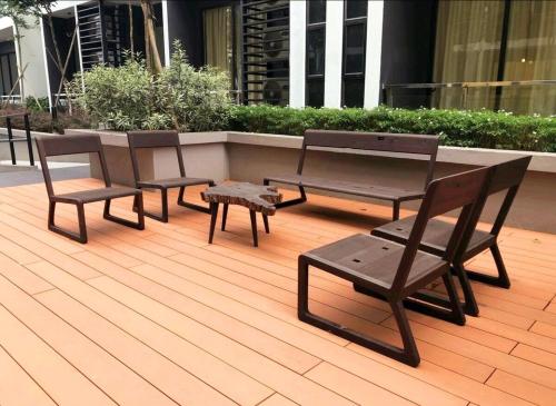 a group of chairs and tables on a patio at SoulHealingPlace Galacity 2BR 2Bed Apartment in Kuching